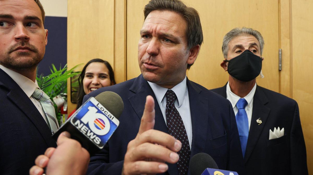 On the issue of critical race theory, Gov. Ron DeSantis has said, “We are going to get the Florida political apparatus involved so we can make sure there’s not a single school board member who supports critical race theory.” In this photo from Monday, May 25, 2021, DeSantis responds to local TV reporter’s question after he signed legislation to make it harder for social media companies to punish users who violate terms of service agreements inside FIU MARC building in Miami, Florida.