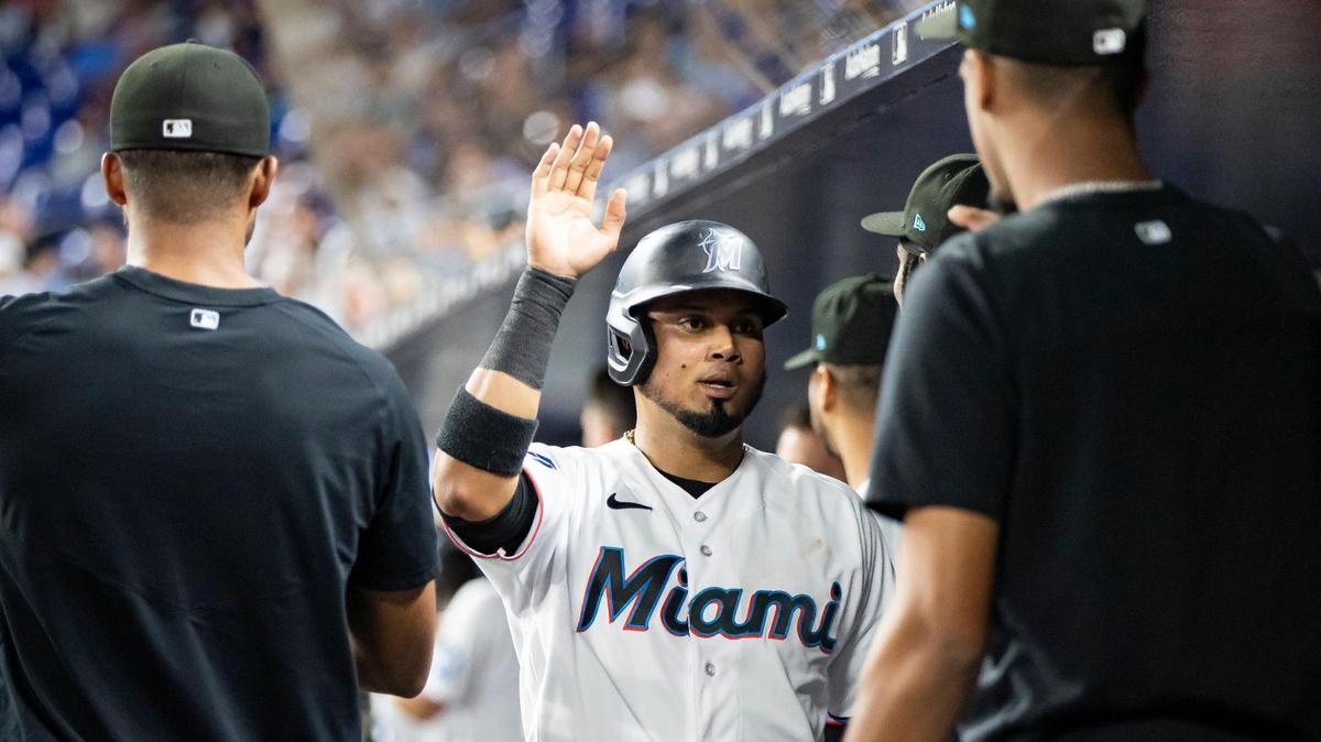 Miami Marlins second baseman Luis Arraez (3) celebrates with teammates after scoring a run against the Toronto Blue Jays in the third inning of an MLB game at loanDepot park on Monday, June 19, 2023, in Miami, Fla.