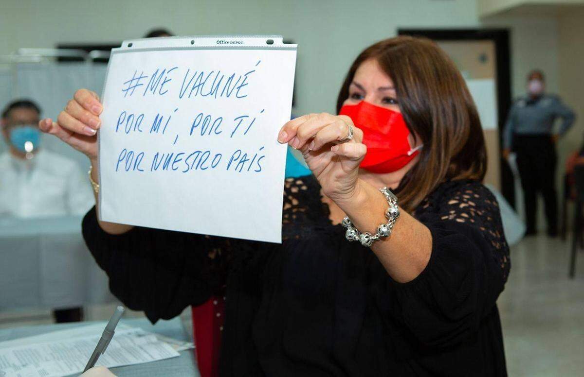 Dr. Iris Cardona, Director of the Vaccination Program of the Puerto Rico Department of Health, holds up a sign that says “#Igotvaccinated for me, for you, for our country” as part of a social media campaign to encourage vaccinations on the island.