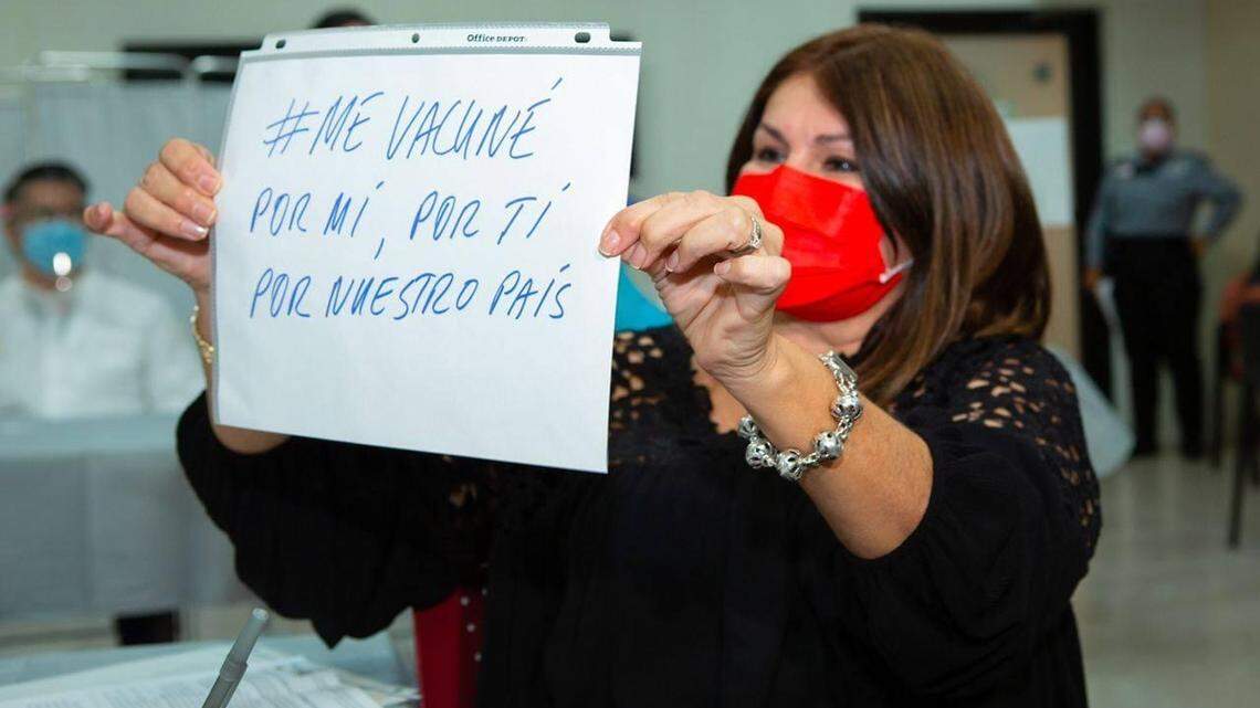Dr. Iris Cardona, Director of the Vaccination Program of the Puerto Rico Department of Health, holds up a sign that says “#Igotvaccinated for me, for you, for our country” as part of a social media campaign to encourage vaccinations on the island.