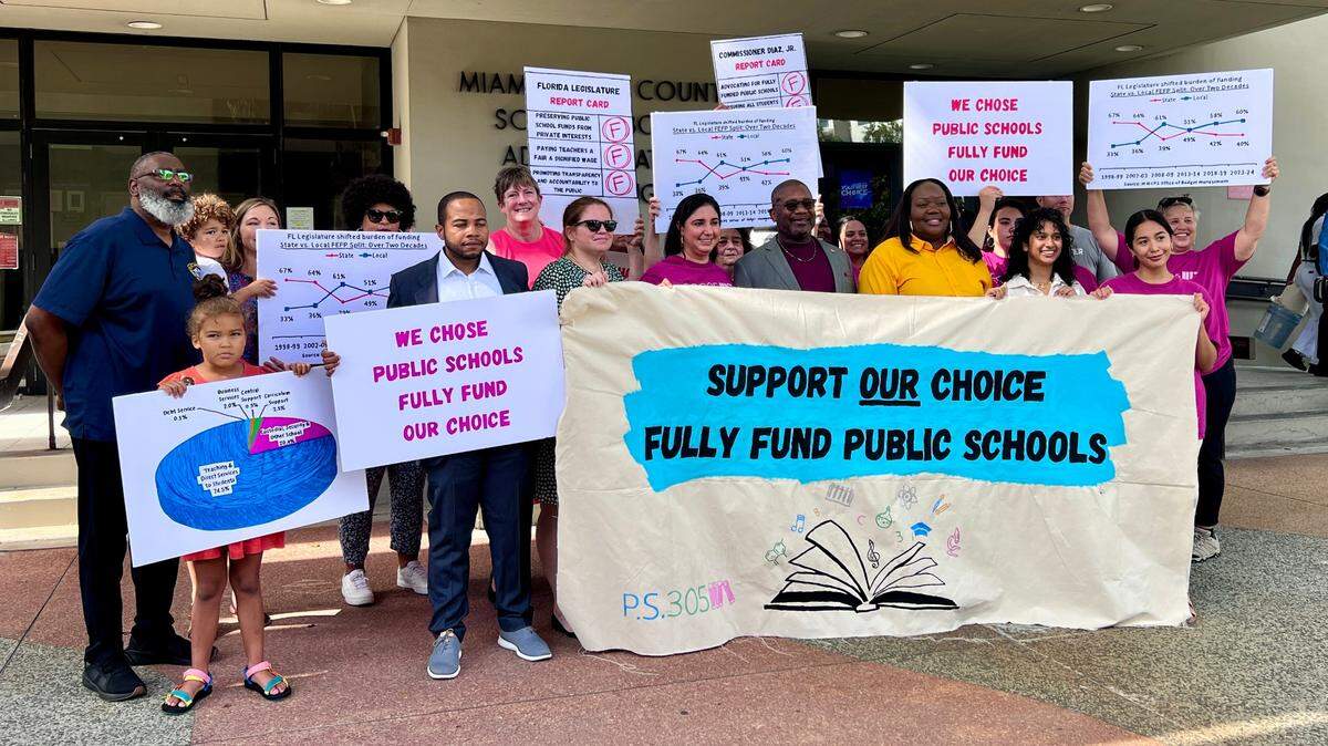 Education advocates, parents pose outside the Miami-Dade County Public School Board Administration Building.