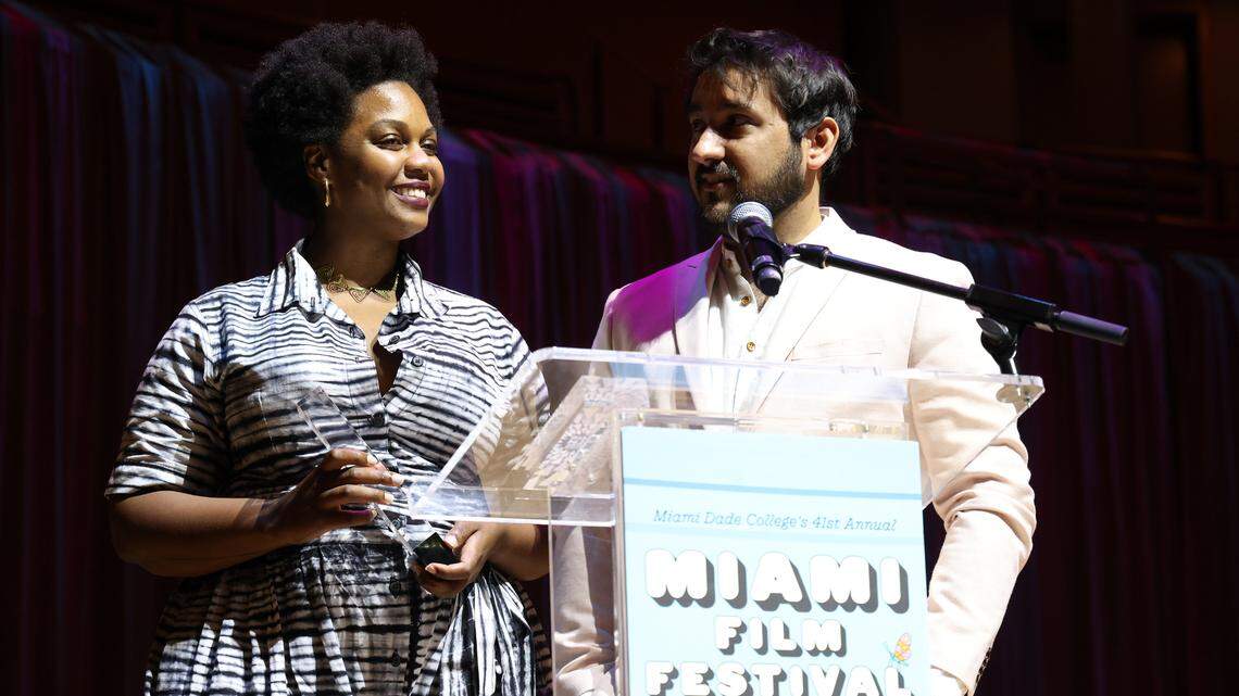 MIAMI, FLORIDA - APRIL 13: Monica Sorelle and Robert Colom speak onstage during the award ceremony and “Ezra” closing night screening during 41st Miami Film Festival at Adrienne Arsht Center for the Performing Arts on April 13, 2024 in Miami, Florida.