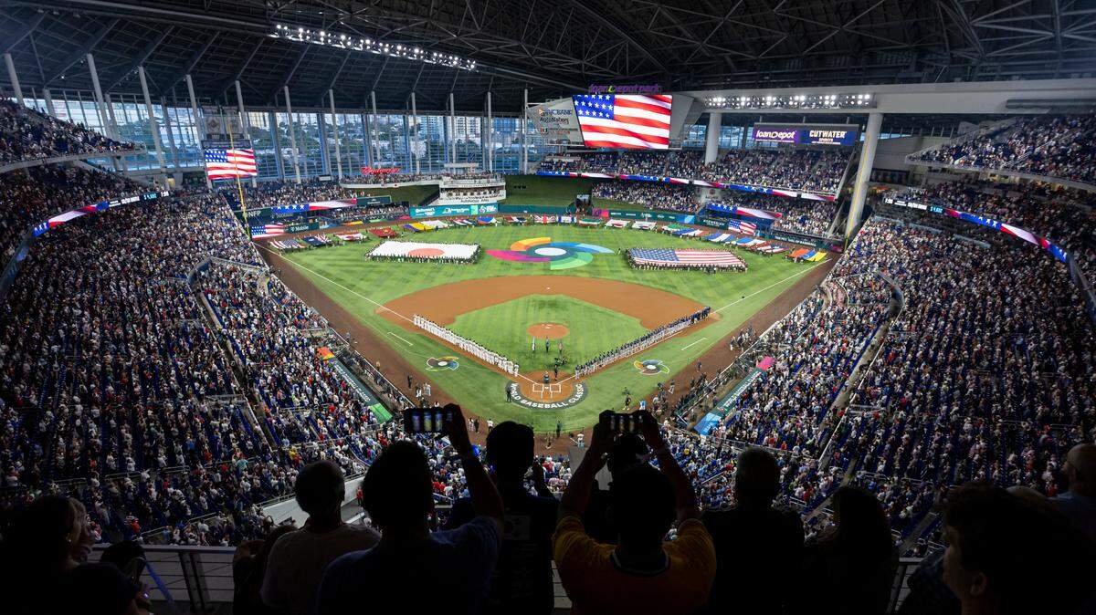 Fans stand for the national anthem before the start of a championship game between USA and Japan at the World Baseball Classic at loanDepot Park on Tuesday, March 21, 2023, in Miami, Fla.
