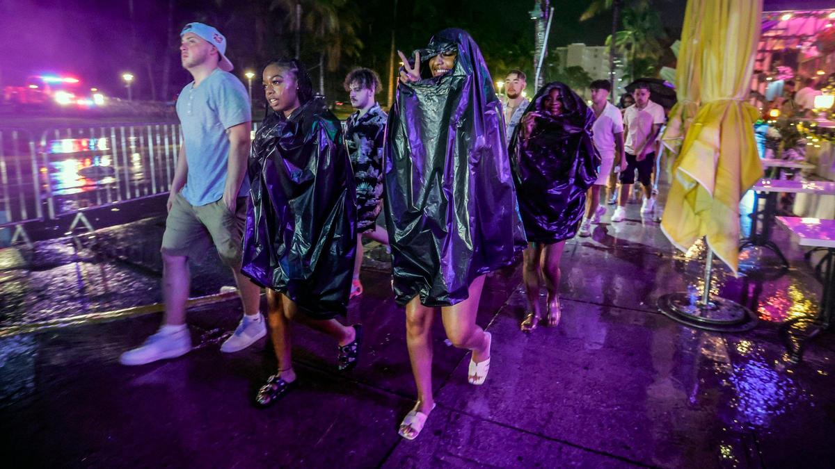 A downpour dampens spring break party along Ocean Drive before midnight curfew on Miami Beach, Florida on Saturday, March 16, 2024.