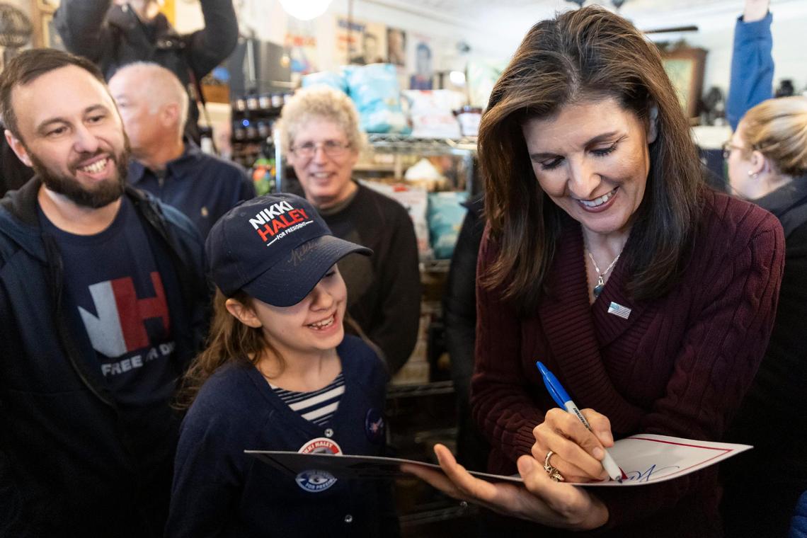 Former United Nations Ambassador Nikki Haley signs autographs during a meet and greet at the Robie Country Store on Thursday, Jan. 18, 2024, in Hooksett, New Hampshire. Polls show Haley trouncing Ron DeSantis for second place in Tuesday’s upcoming primary vote.
