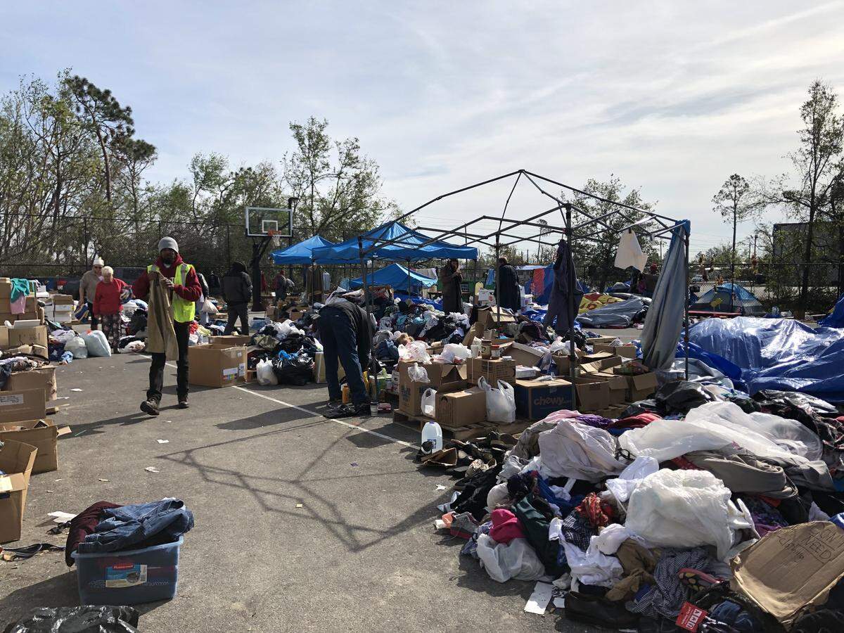 People search piles of donations left outside Forest Park Methodist Church in Panama City, where about 250 people, including several children, after Hurricane Michael slammed the Panhandle on Oct. 10.