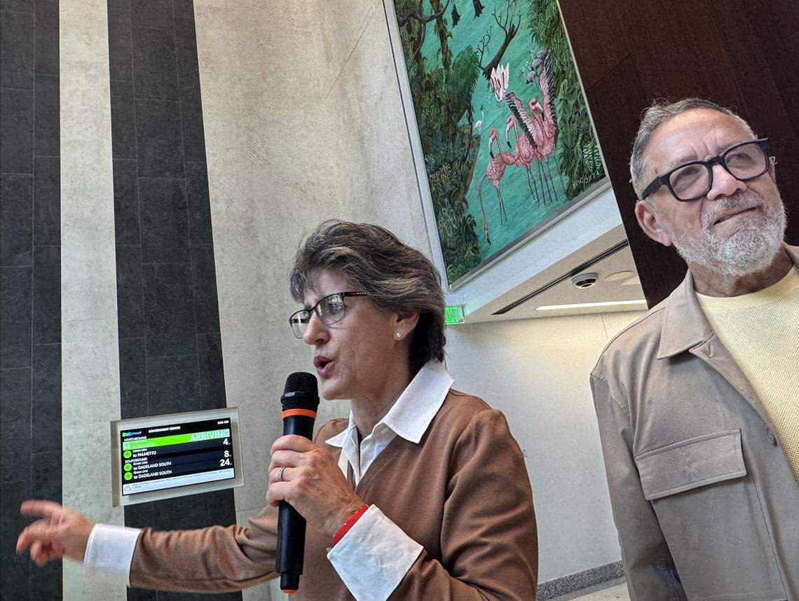Haiti-born contemporary artist and curator Edouard Duval-Carrié, right, welcomes visitors to the Osvaldo N. Soto Miami-Dade Justice Center which features two large murals in the lobby created by the artist. 