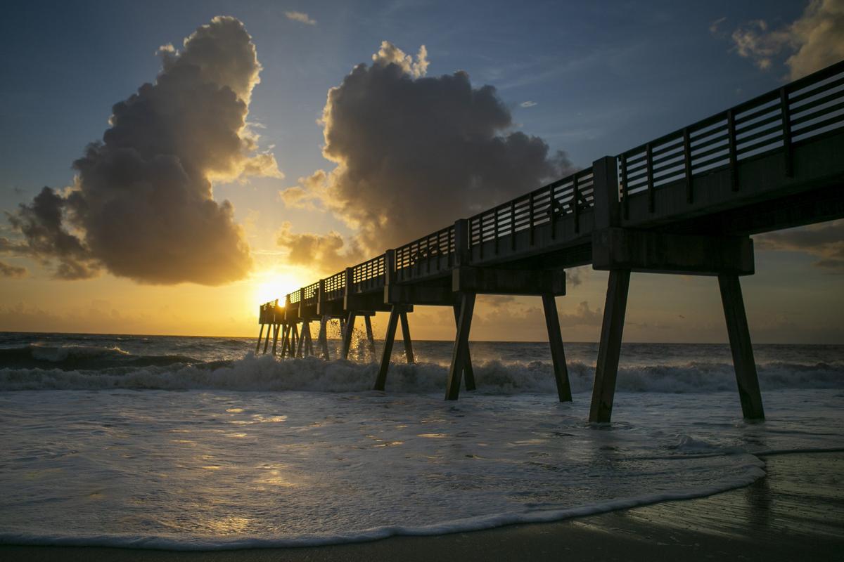 The sun rises over a private pier in Vero Beach, Florida on Sunday, Sept. 1, 2019 as Hurricane Dorian continues to pose a potential threat to the coastal town.