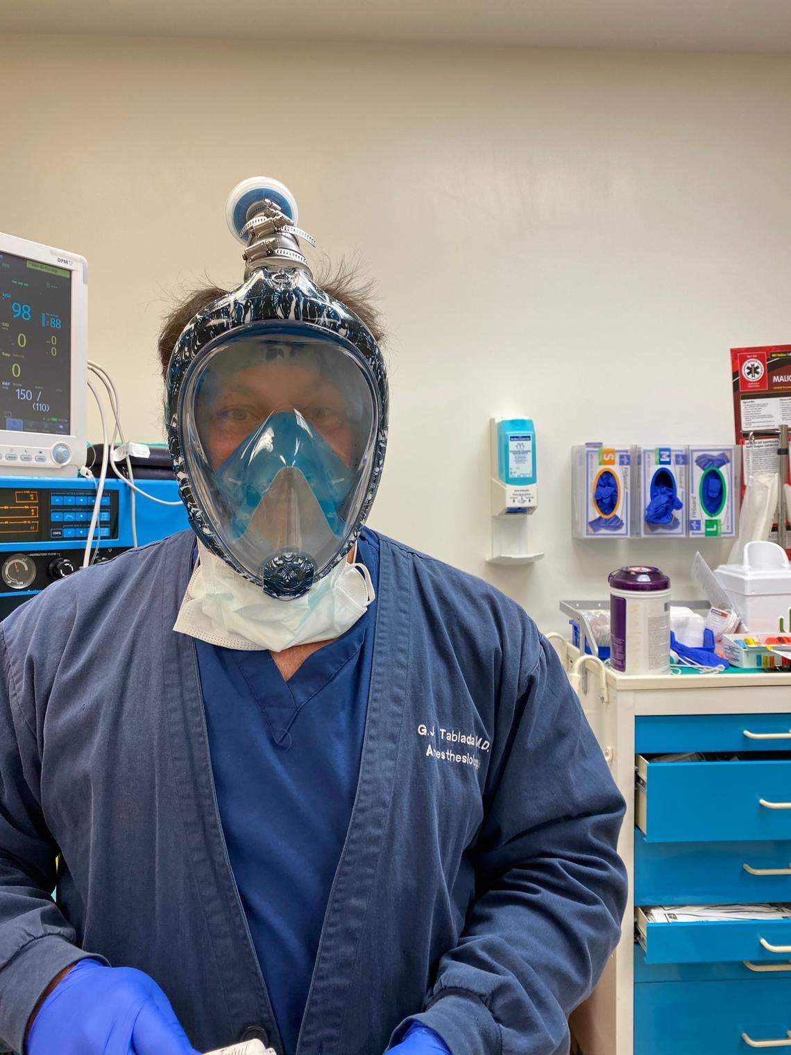 Dr. Guillermo Tablada, an anesthesiologist at the University of Miami, wears a snorkeling mask retrofitted with a filter from an N95 mask. Some doctors see this as a protection measure of last resort as masks become harder to get.
