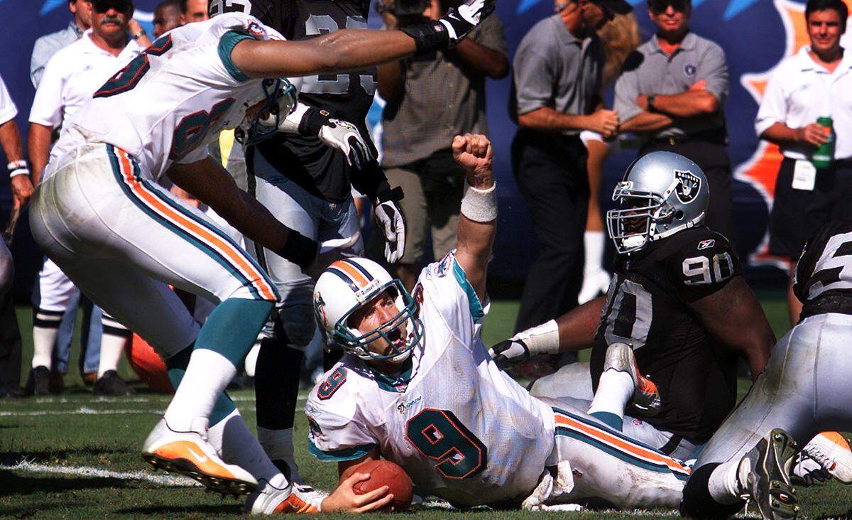 The Miami Dolphins host the Oakland Raiders at Pro Player Stadium in Miami on Sept. 23, 2001. Jay Fiedler raises his fist after scoring the winning TD on a 2 yard run.