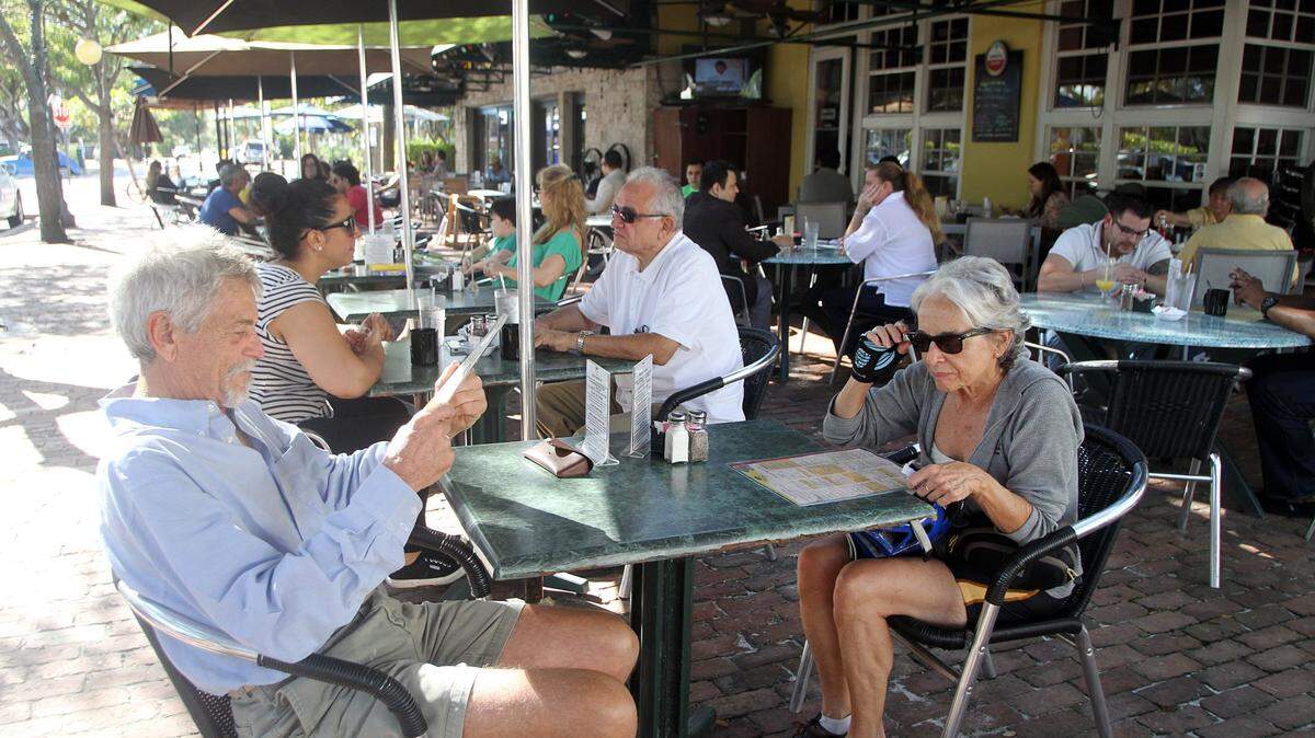 The original Deli Lane location is set to close in a few years after catching the eye of a real estate development firm. Above: From front left, Skip Richheimer and Fredericka Smith enjoy brunch at Deli Lane Cafe and Tavern in South Miami on Friday, Dec. 6, 2013.