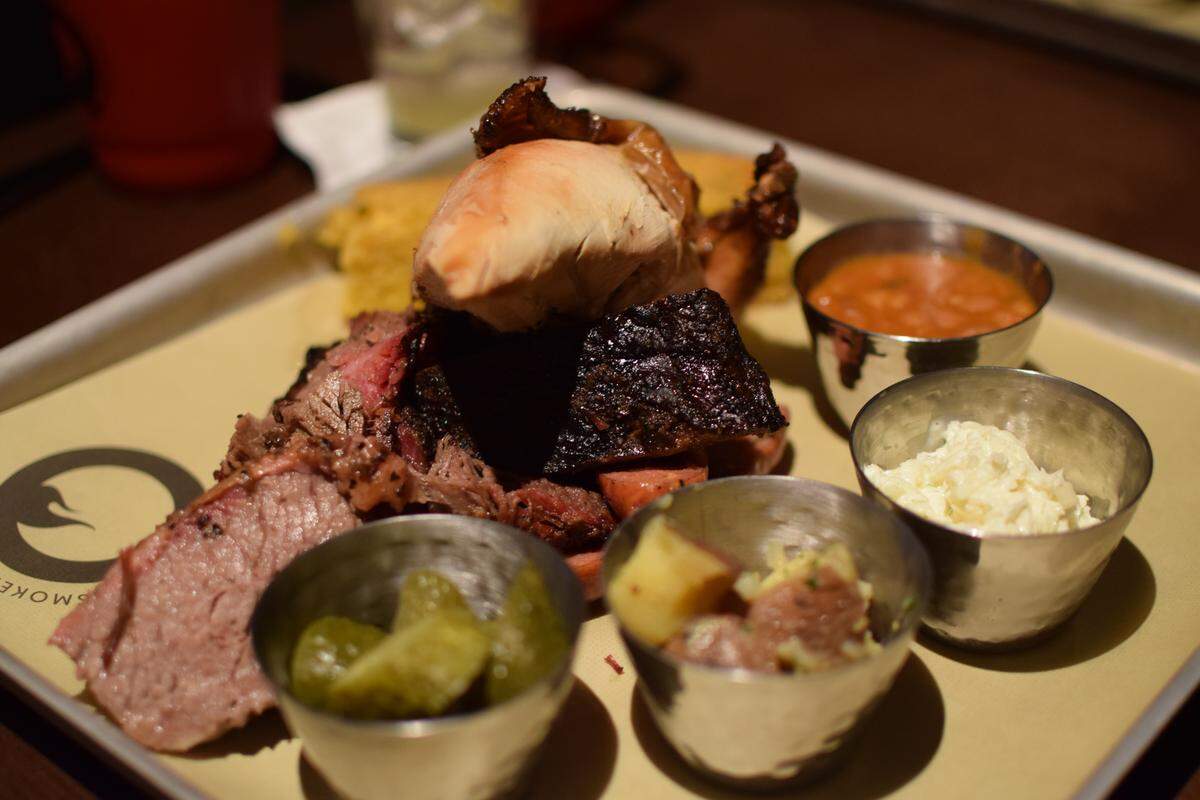 The Pitmaster Platter at Q on Norwegian Bliss includes a quarter pound each of brisket, pork spare ribs, jalapeño and cheese sausage, and smoked chicken, plus five sides.