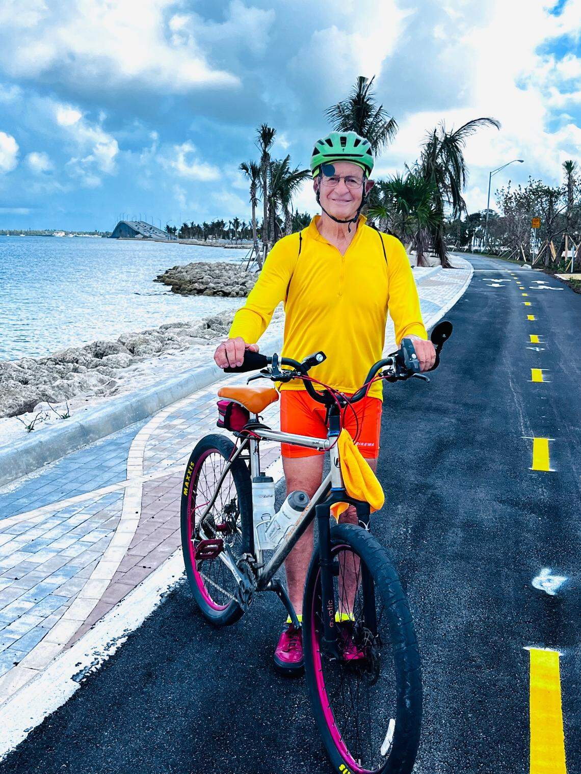 Cycling advocate Tom Burton, 80, a retired pilot, pauses while riding on the bike path at the newly restored Hobie Island North Beach park on Miami’s Rickenbacker Causeway.