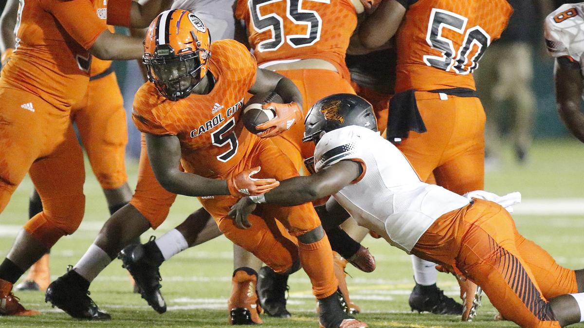 Carol City Chiefs running back Nay’quan Wright (5) tries to break free from Booker T. Washington Tornadoes defenders during the football game on Thursday, October 18, 2018 at Traz Powell stadium in Miami