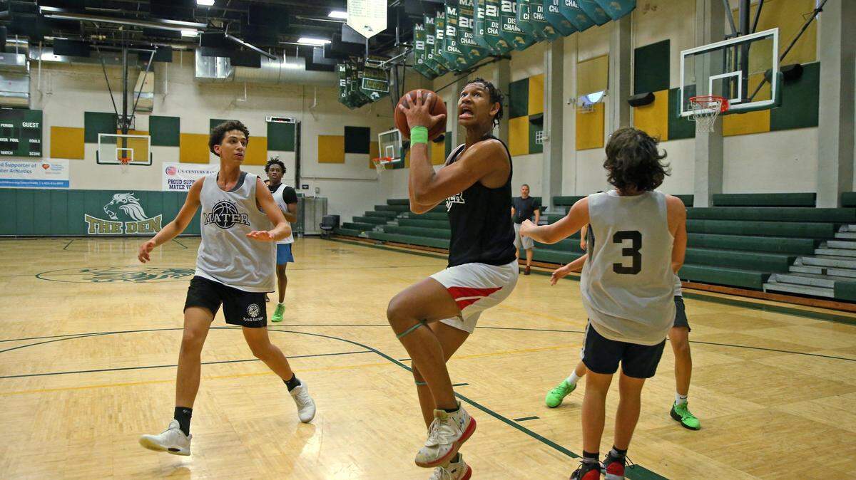 Mater Academy basketball center Malik Reneau, center, shown during practice in November, scored 34 points and grabbed 16 rebounds to lead the Lions into the Junior Orange Bowl tournament final.