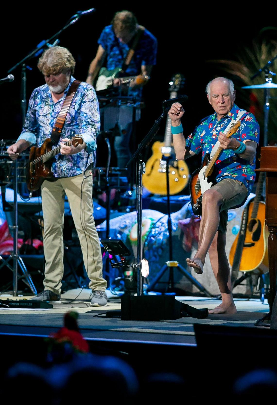 Jimmy Buffett (right) and his Coral Reefer Band, including Mac McAnally (left), perform during their concert at the iTHINK Financial Amphitheatre in West Palm Beach, Florida on Thursday, December 9, 2021.