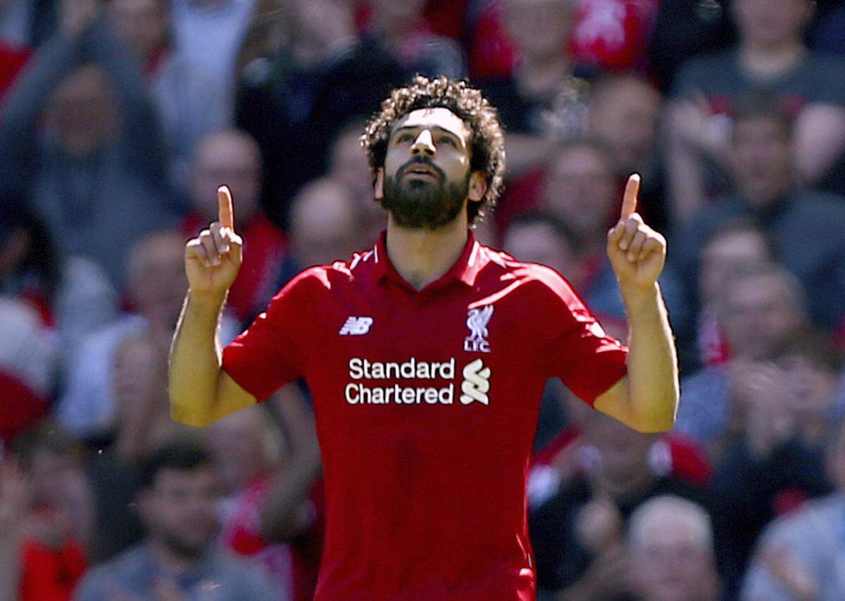Liverpool's Mohamed Salah celebrates scoring his side's first goal of the game during their English Premier League soccer match against Brighton & Hove Albion at Anfield, Liverpool. England, Sunday, May 13, 2018.