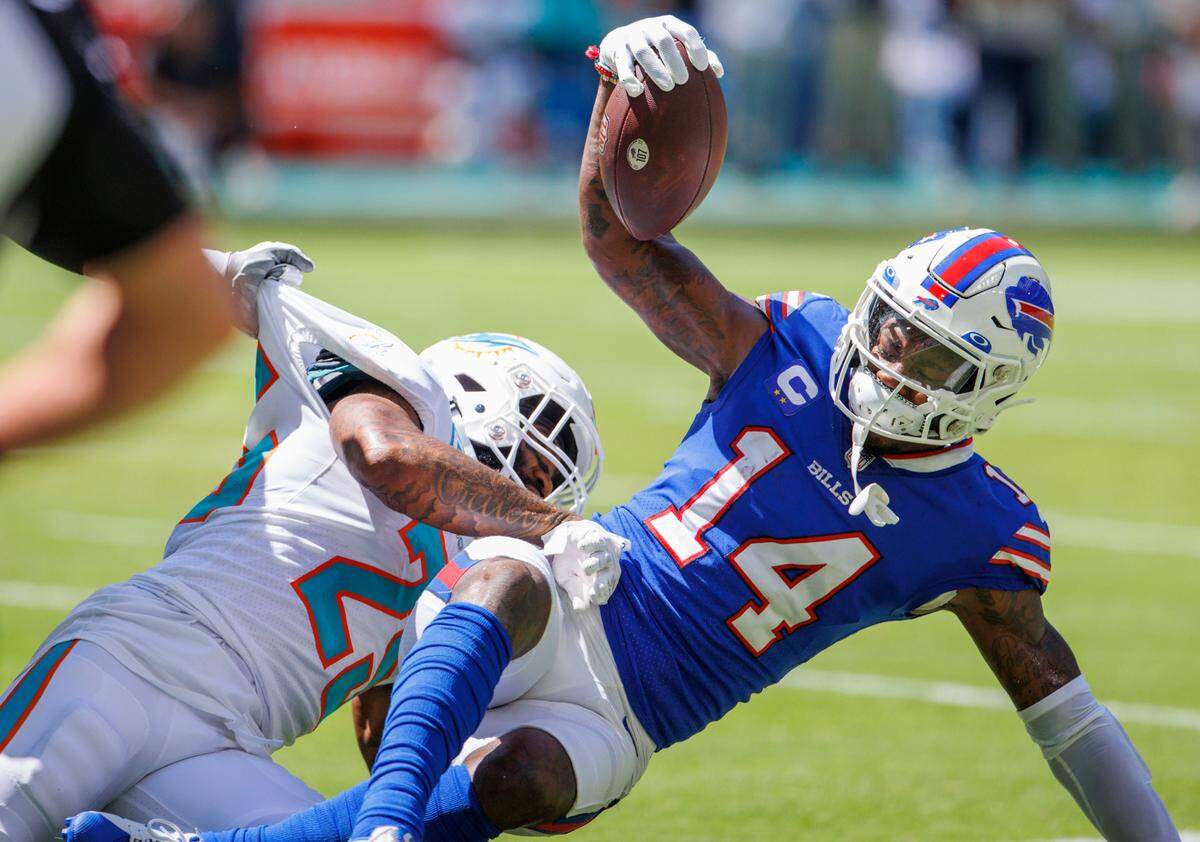Miami Dolphins cornerback Xavien Howard (25) tackles Buffalo Bills wide receiver Stefon Diggs (14) during the first quarter of an NFL football game at Hard Rock Stadium on Sunday, September 25, 2022 in Miami Gardens, Florida.