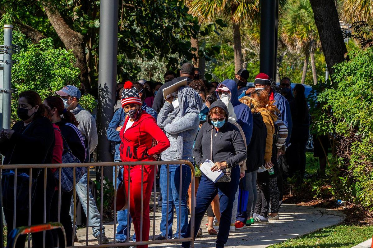 City of Miami residents lined up to receive a free $250 Publix gift card on Tuesday, December 01, 2020. The gift cards are part of a program, funded by CARES Act dollars, to help families buy groceries during the holidays as they struggle with the COVID-19 pandemic. This was the first of five distribution events planned by the city during December.
