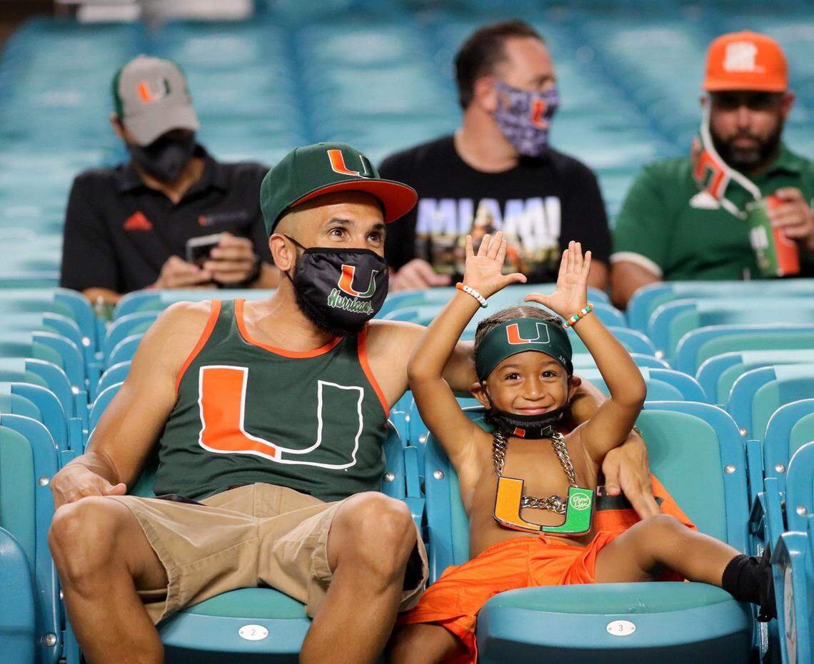 Armando Espinoza and his son Armando 3, of Belle Glade, watch as the University of Miami hosts the UAB Blazers at Hard Rock Stadium in Miami Gardens on Thursday, September 10, 2020.
