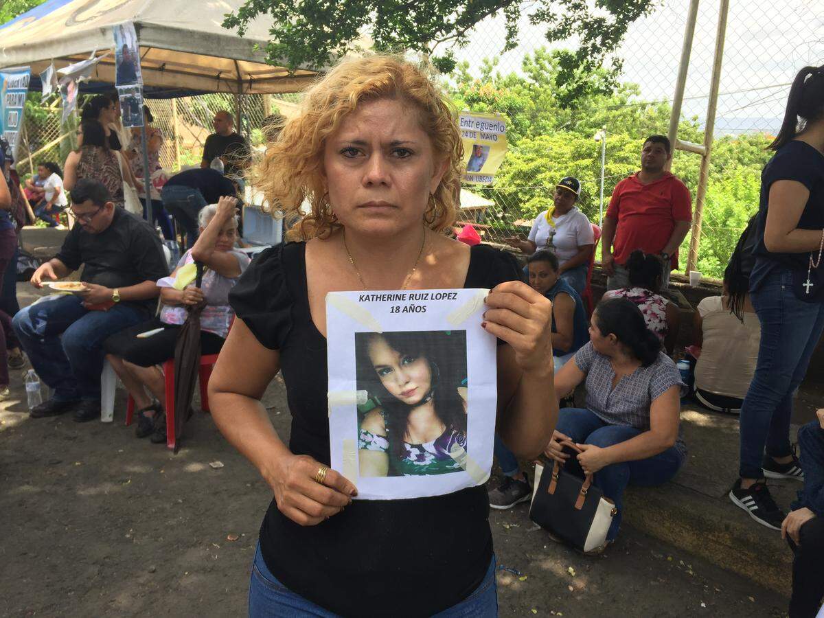 Verónica López stands outside El Chipote jail in Managua holding a photograph of her 18-year-old daughter Katherine Ruiz López, a university student who disappeared on May 24.