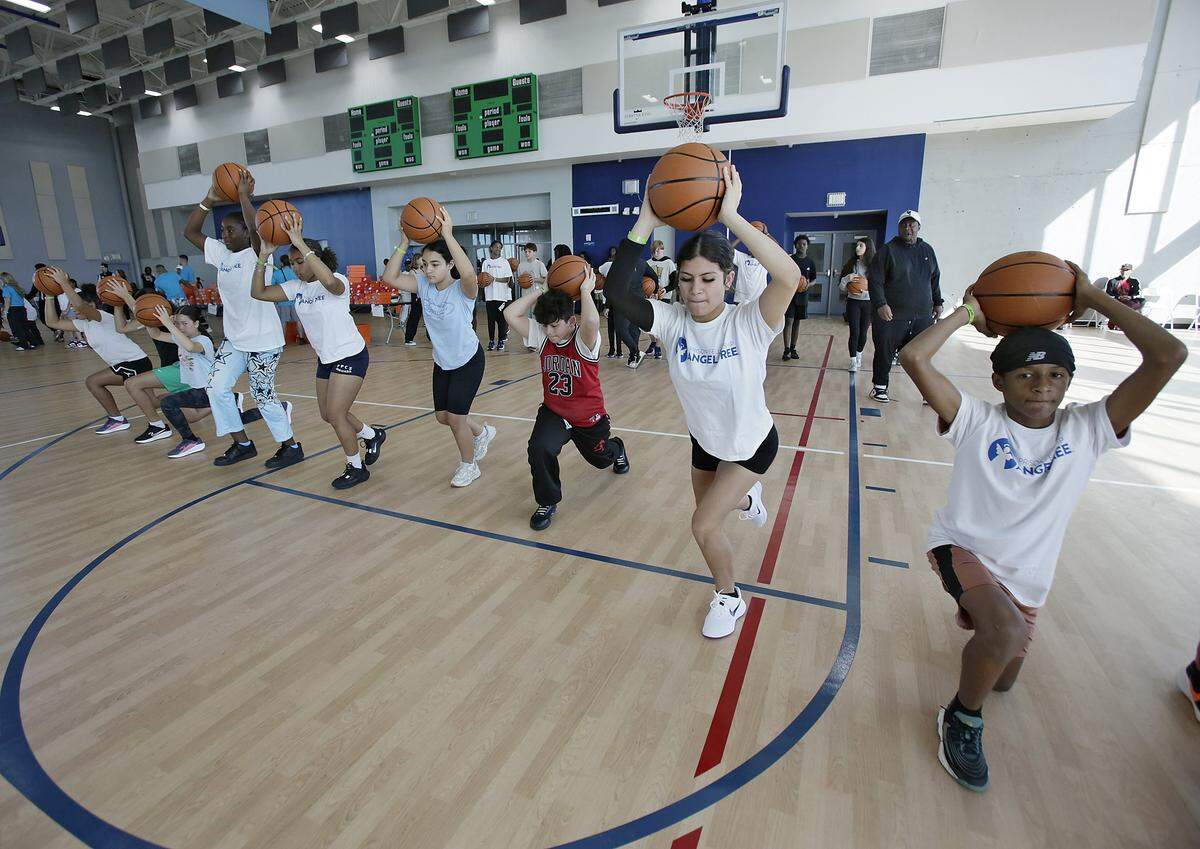 Participants in the Prison Fellowship Angel Tree sports camp exercise while holding basketballs on Saturday, November 15, 2025 in Miami. Andrew Uloza / for Miami Herald