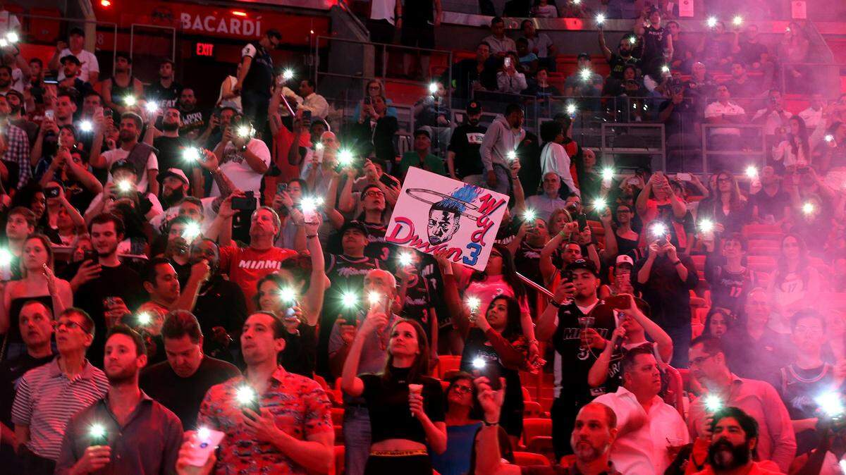 Miami Heat fans light up the arena with their cell phones as they play the Boston Celtics at the AmericanAirlines Arena in Miami, Florida, Wednesday, April, 3, 2019.