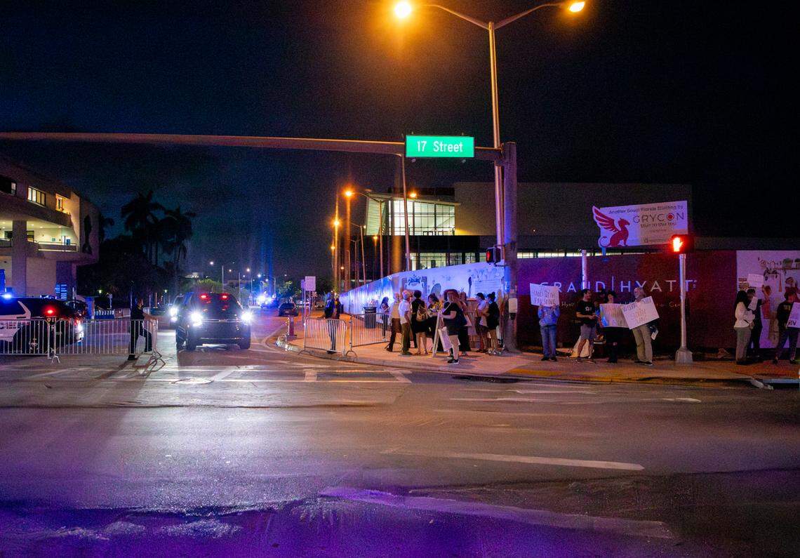 Police open up barricades for a car leaving the Aspen Ideas conference as pro-Palestinian protesters stand on the street in front of the barricades on 17th Street in Miami Beach.