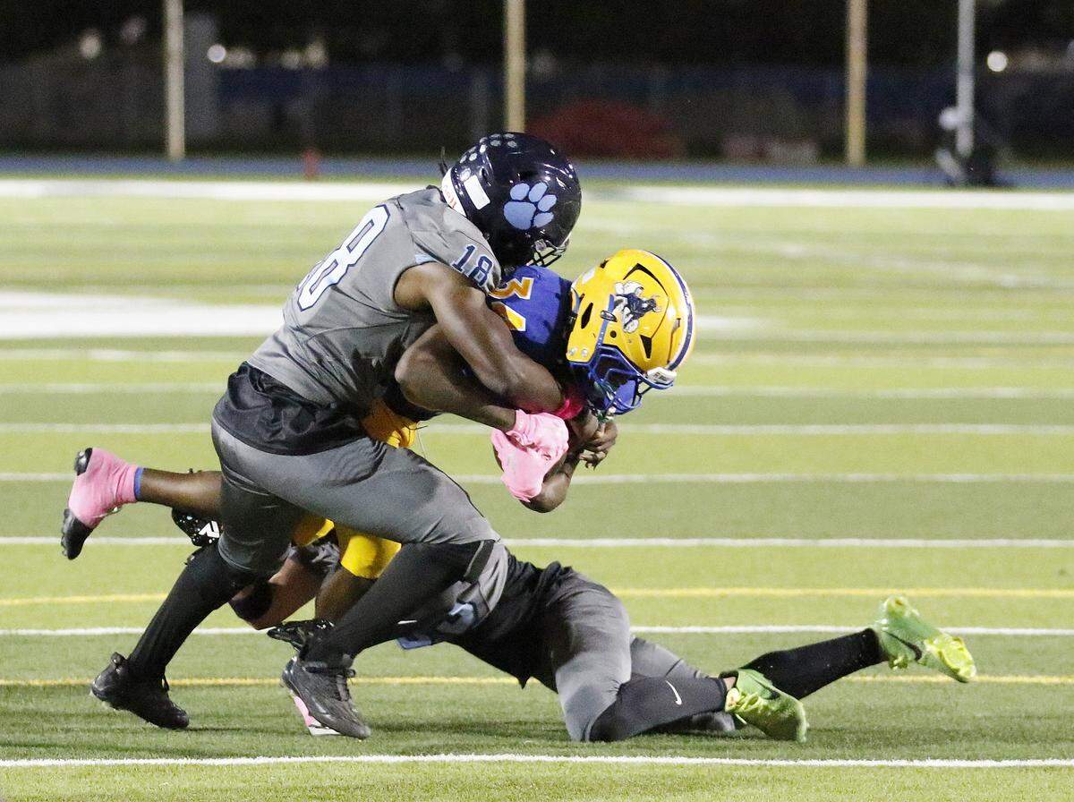 Palmetto Panthers linebacker Prince Smith (18) tackles Northwestern Bulls running back Tarvail Mathis during football game on Friday, October 17, 2025 at Traz Powell Stadium in Miami. Andrew Uloza / for Miami Herald