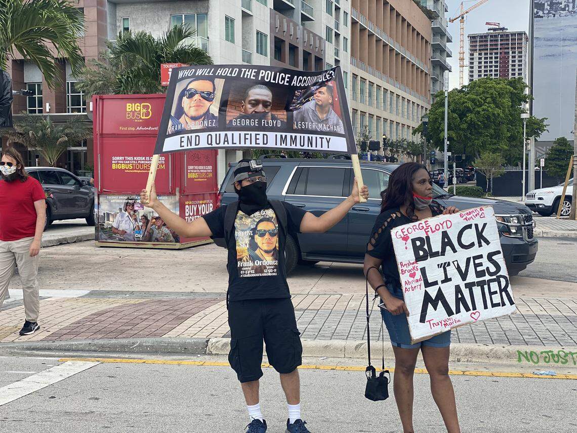 Roy Ordóñez, brother of the late Frank Ordóñez, the UPS driver killed in a police shootout in Dec. 2019, holds up a banner showing the face of his brother, George Floyd and Lester Machado, who was killed by Hialeah police in Oct. 2017.