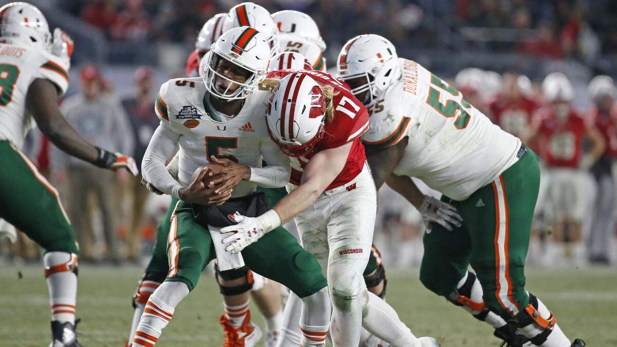 Miami Hurricanes quarterback N’Kosi Perry (5) is sacked by Wisconsin Badgers linebacker Andrew Van Ginkel (17) in the fourth quarter of the Dec. 27 Pinstripe Bowl. The Dolphins drafted Van Ginkel in the fifth round.