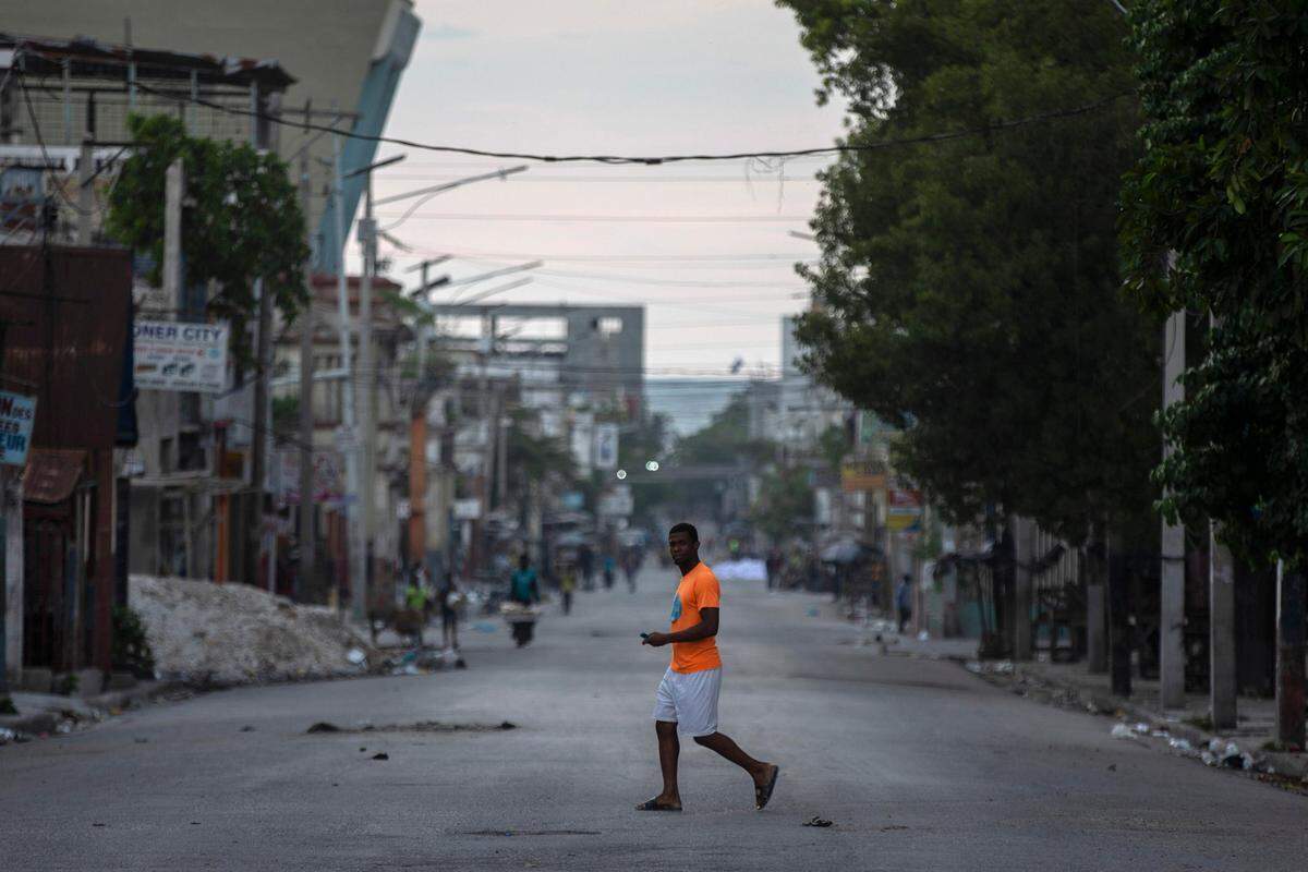 A man walks through a street empty of traffic due to a general strike in Port-au-Prince, Haiti, Monday, Oct. 18, 2021. Workers angry about the nation’s lack of security went on strike in protest two days after 17 members of a U.S.-based missionary group were abducted by a violent gang.