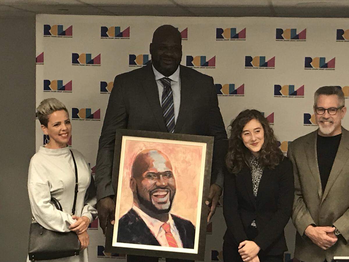 Shaquille O’Neal stands with a portrait of himself during his visit to Sarasota on Wednesday, Jan. 16, 2019 for the Ringling College Library Association Town Hall Lecture Series at the Van Wezel Performing Arts Hall. Valerie Strenk (right) and Scott Gordley (far left), of the Ringling College, pose with O’Neal and Jamie Green, who illustrated the portrait.
