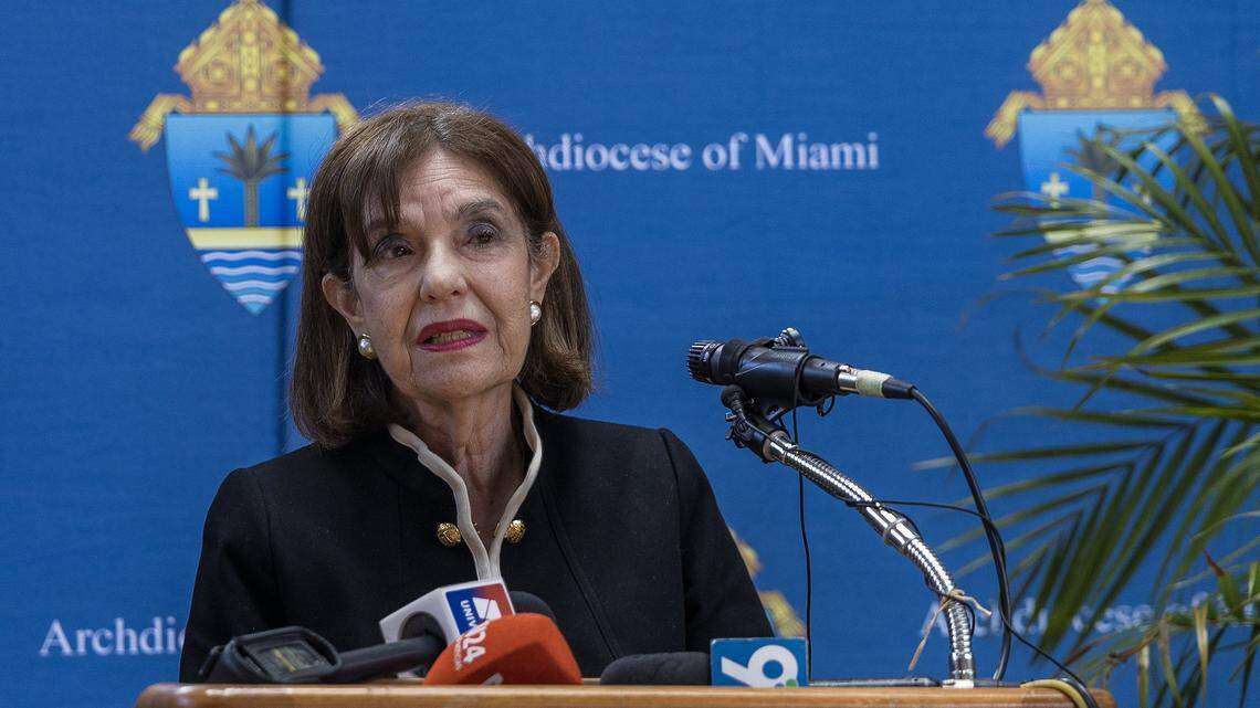 Dr. Graciela Anrrich, 1st Vice President, of the Pedro Pan Board of Directors, speaks during a press conference held by the Archdiocese of Miami, to address the abrupt cancellation of an $11 million federal contract with Catholic Charities, in addition to the immediate and long-term impact on services for unaccompanied minors and the broader humanitarian mission of the Archdiocese. The contract supported shelter and care for unaccompanied migrant children entering the United States, in Miami Shores, on Thursday, April 16, 2026.