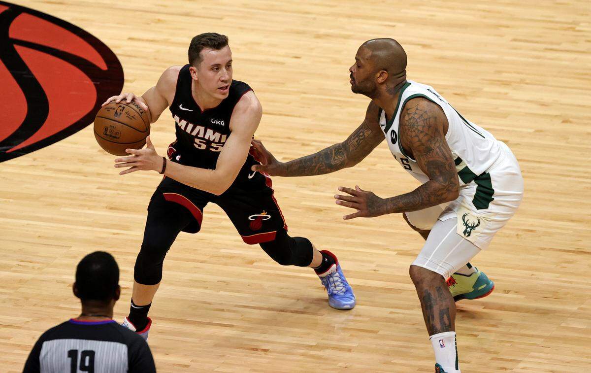 Miami Heat forward Duncan Robinson (55) drives against Milwaukee Bucks forward P.J. Tucker (17) during the first quarter of Game 3 of their first-round playoff series on May 27, 2021 at AmericanAirlines Arena.
