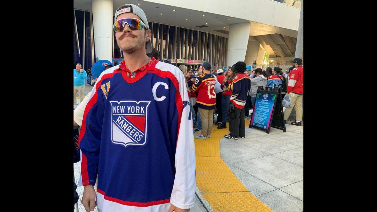 Outside loanDepot Park, awaiting the arrival of the New York Rangers and Florida Panthers for the NHL Winter Classic, Rangers fan Joey Cross wears the NHL Vintage reissue of New York’s 1976-78 road jersey with the captain’s “C” and center Phil Esposito’s No. 77 on his left sleeve.