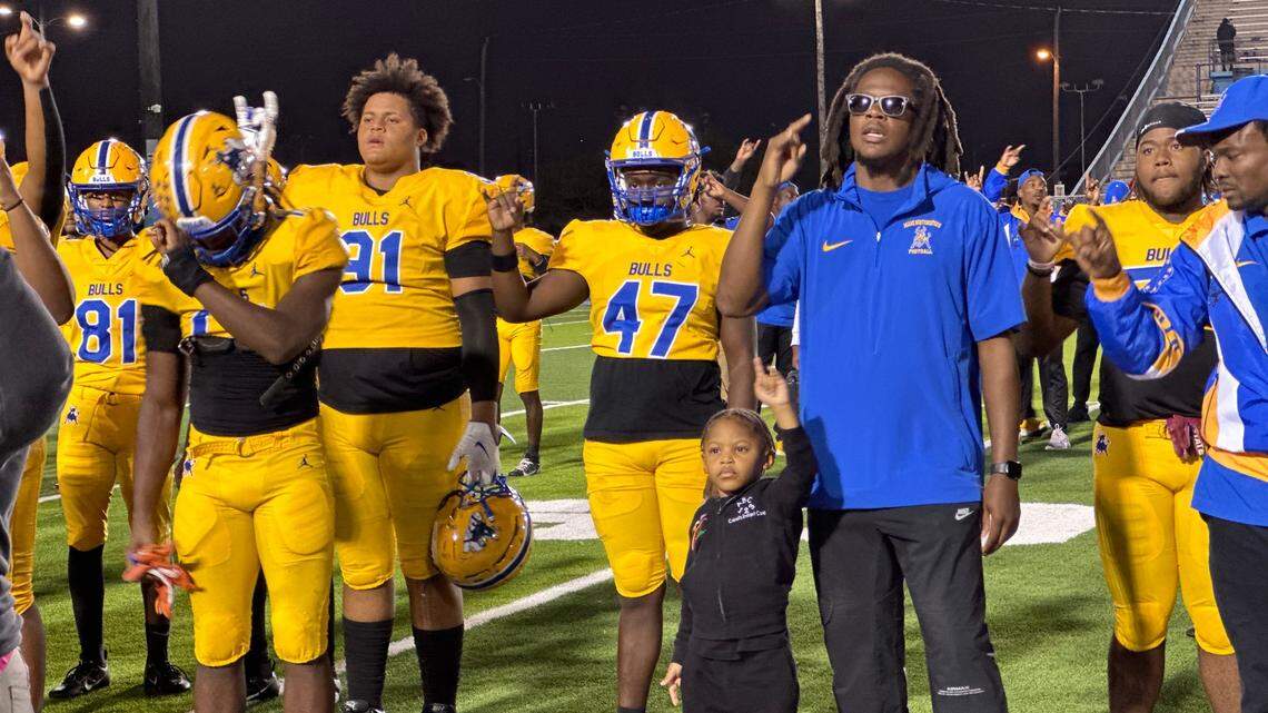 Miami Northwestern football coach Teddy Bridgewater (right) sings the school’s alma mater with his players after the Bulls beat Columbus on Thursday night at Traz Powell Stadium in Miami, Fla.