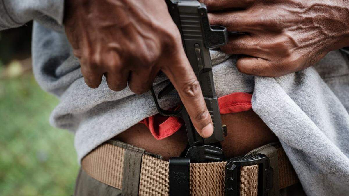 A man shows his Sig Sauer P365 that he always carries in a holster in Atlanta, Georgia, on November 4, 2024. (Photo by Yasuyoshi CHIBA / AFP) (Photo by YASUYOSHI CHIBA/AFP via Getty Images)