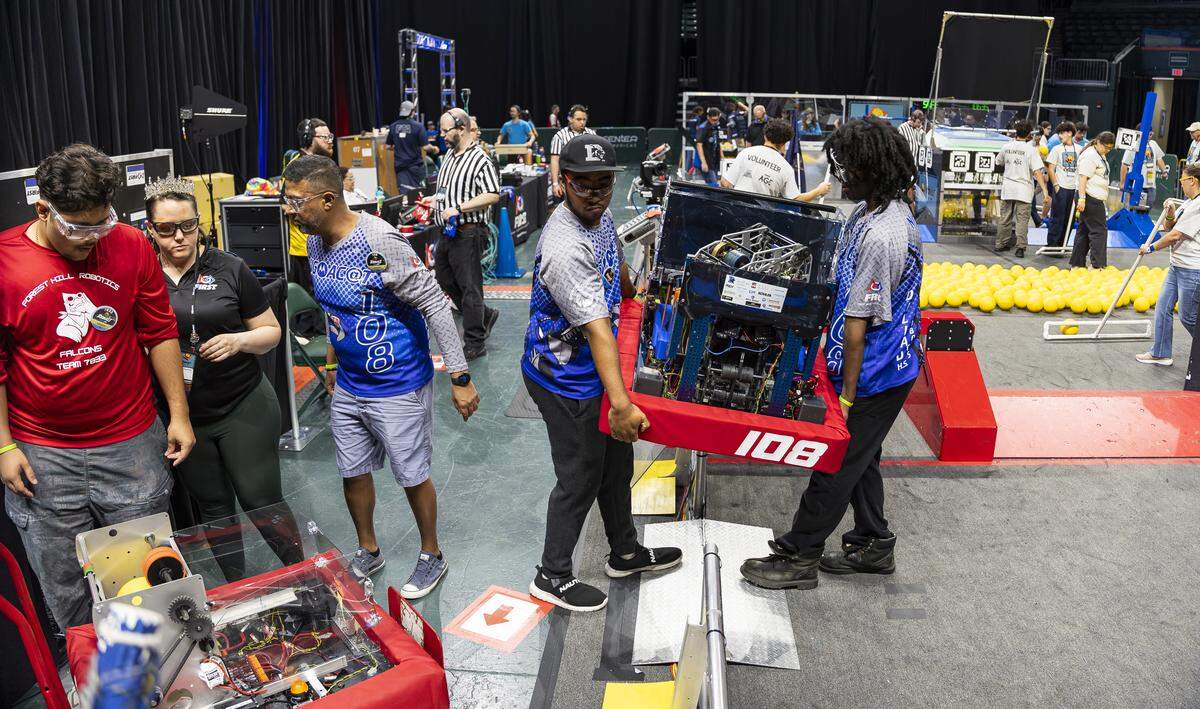 Dillard High School students with Team 108 SigmaC@T Robotics lift their robot after they participated in the 2026 FIRST Robotics South Florida Regional Competition at the University of Miami’s Watsco Center on Friday, April 10, 2026, in Coral Gables, Fla. Participants from local school districts, surrounding states, and international teams are competing for an opportunity to earn a spot at the 2026 FIRST World Championship.