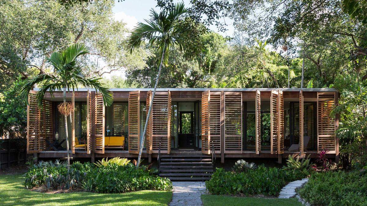 Architects Melissa and Jacob Brillhart designed their Spring Garden house to harmonize with the surrounding foliage, with a nod to pre-air conditioning vernacular days.