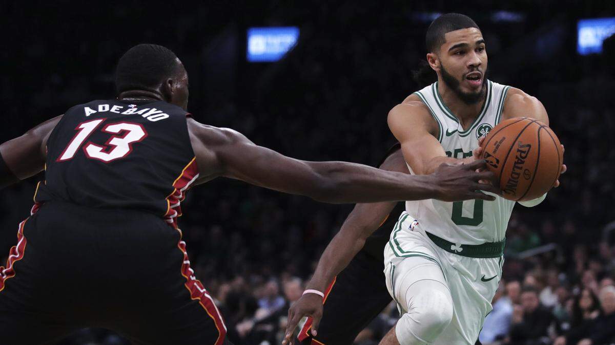 Celtics forward Jayson Tatum (0) drives to the basket against Heat center Bam Adebayo (13) during the first half of an NBA basketball game in Boston, Wednesday, Dec. 4, 2019.