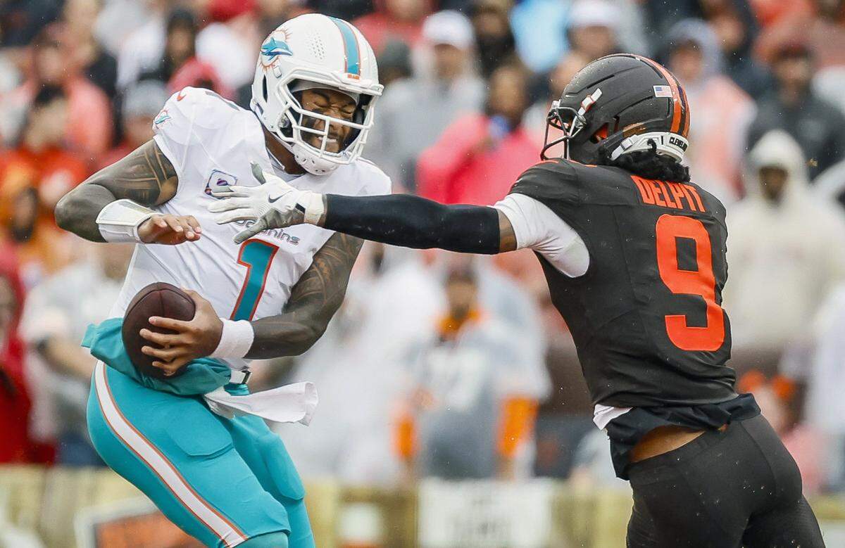 Miami Dolphins quarterback Tua Tagovailoa (1) is sacked by Cleveland Browns safety Grant Delpit (9) during the first half of an NFL football game at Huntington Bank Field in Cleveland, Ohio, on Sunday, October 19, 2025.