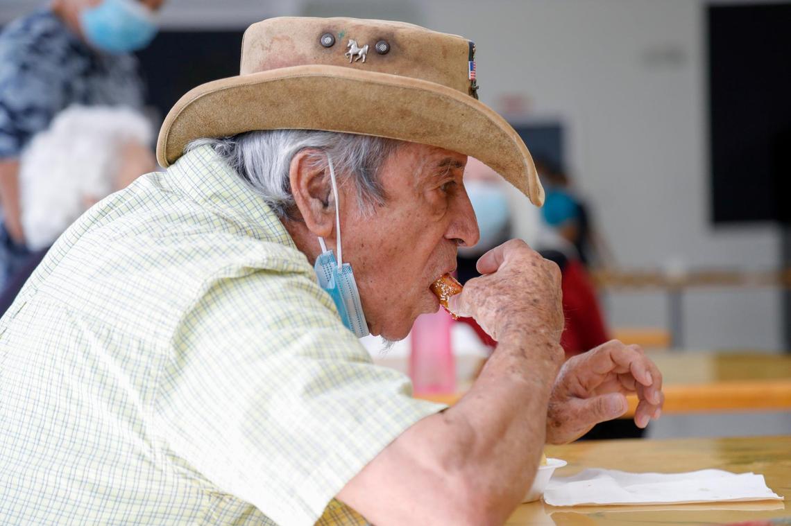 Hugo Arbelaez, 83, eats a pastelito while listening to live salsa music in the cafeteria at Mia Casa, the former assisted living center in North Miami that the Miami-Dade County Homeless Trust is leasing to take care of homeless seniors.