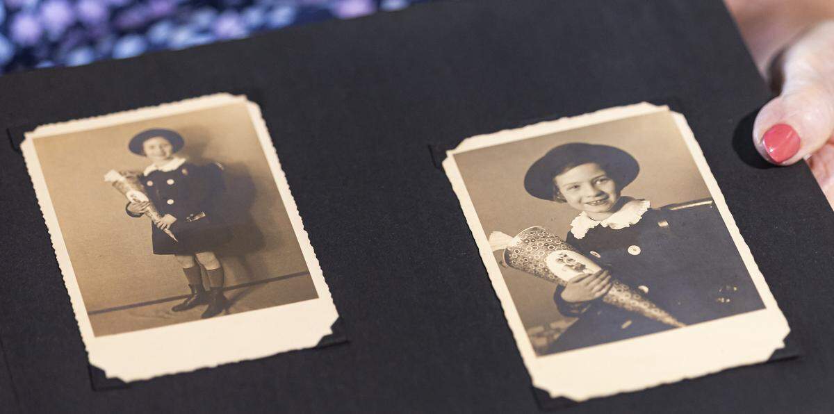 Ruth Di Stefano, a 97-year-old Holocaust survivor, holds a scrapbook with childhood photos at her Fort Lauderdale home. Di Stefano received a holiday gift bag and meal from Goodman Jewish Family Services in anticipation of the Rosh Hashana holiday.
