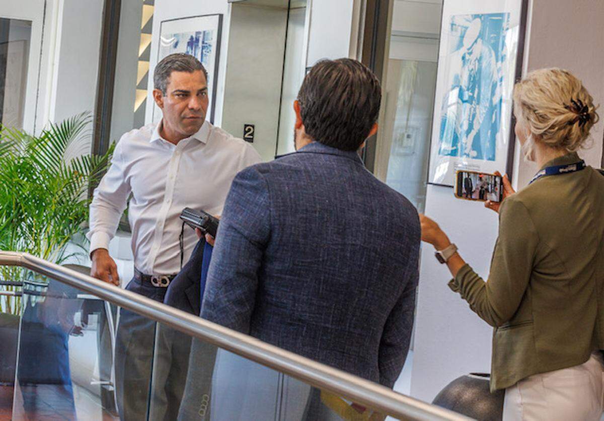 El alcalde de la ciudad de Miami Francis Suárez reaccionando mientras los reporteros de Miami Herald Sarah Blaskey y Joey Flechas le hacen preguntas antes de entrar en su despacho el sábado 9 de septiembre de 2023.