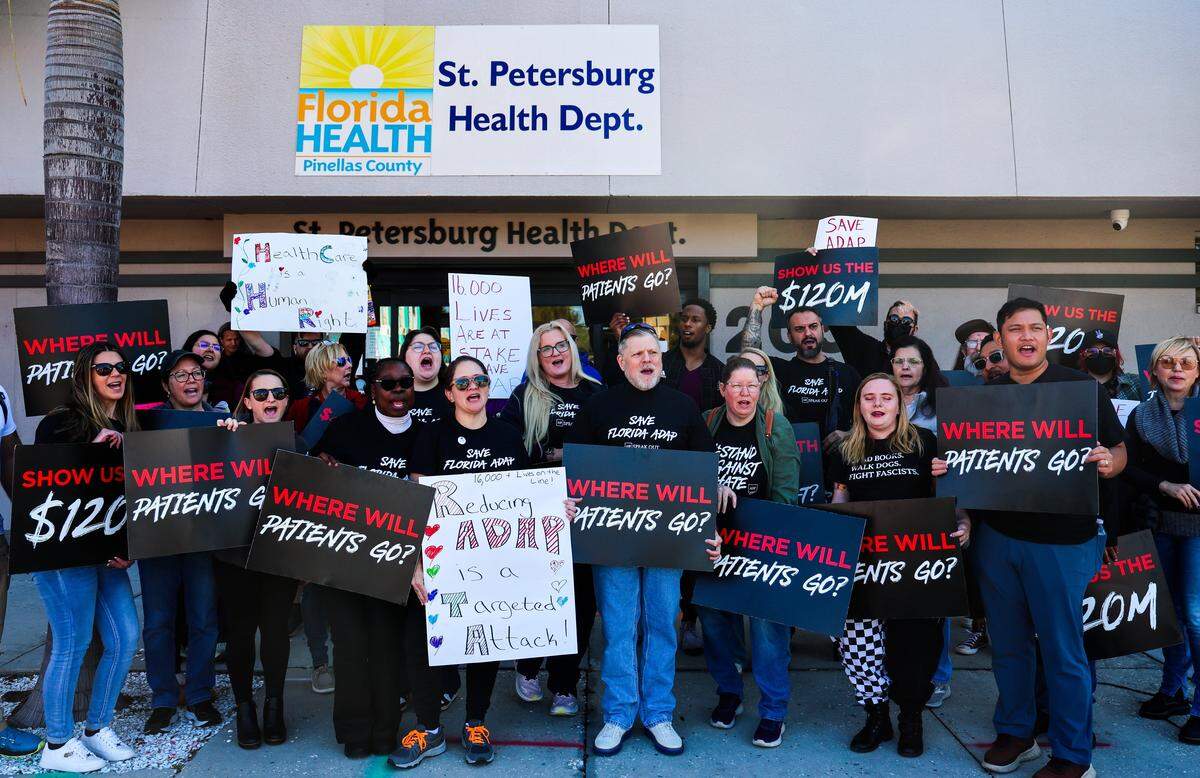 AHF Healthcare Center physicians and employees during a protest outside of the Pinellas County Florida Department of Health office on Friday, Jan. 30, 2026 in St. Petersburg. The AIDS Healthcare Foundation held protests at the county health department in Pinellas and in Orange County demanding that the state undo their cuts to the AIDS Drug Assistance Program. AHF if also suing the state to try and stop the cuts. Cuts are set to take effect March 1. AHF Healthcare Centers provide advanced medical care designed specifically for people living with HIV.