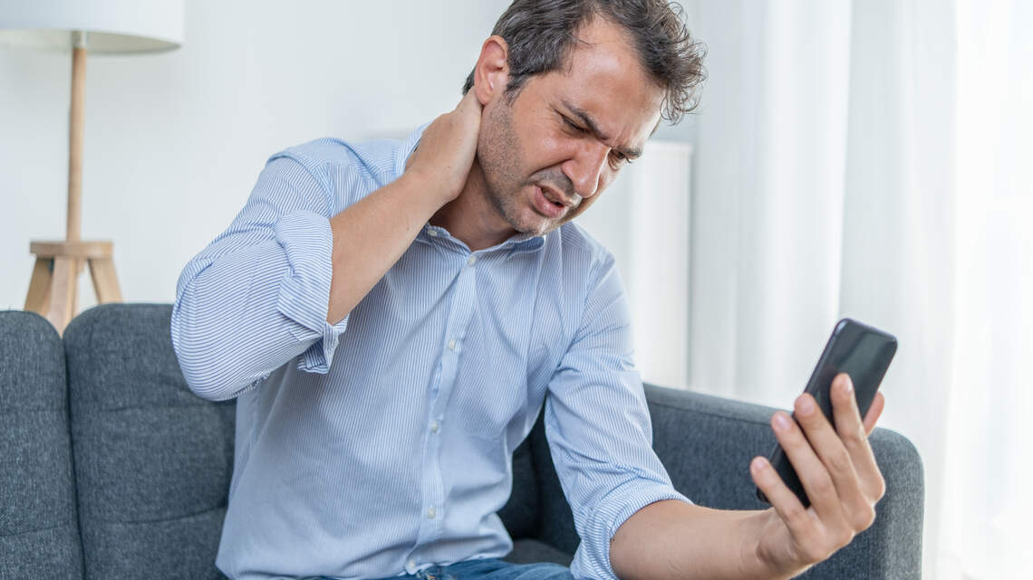 Could your phone be causing your neck pain? Experts reveal the top risk factors and how to ease the ache