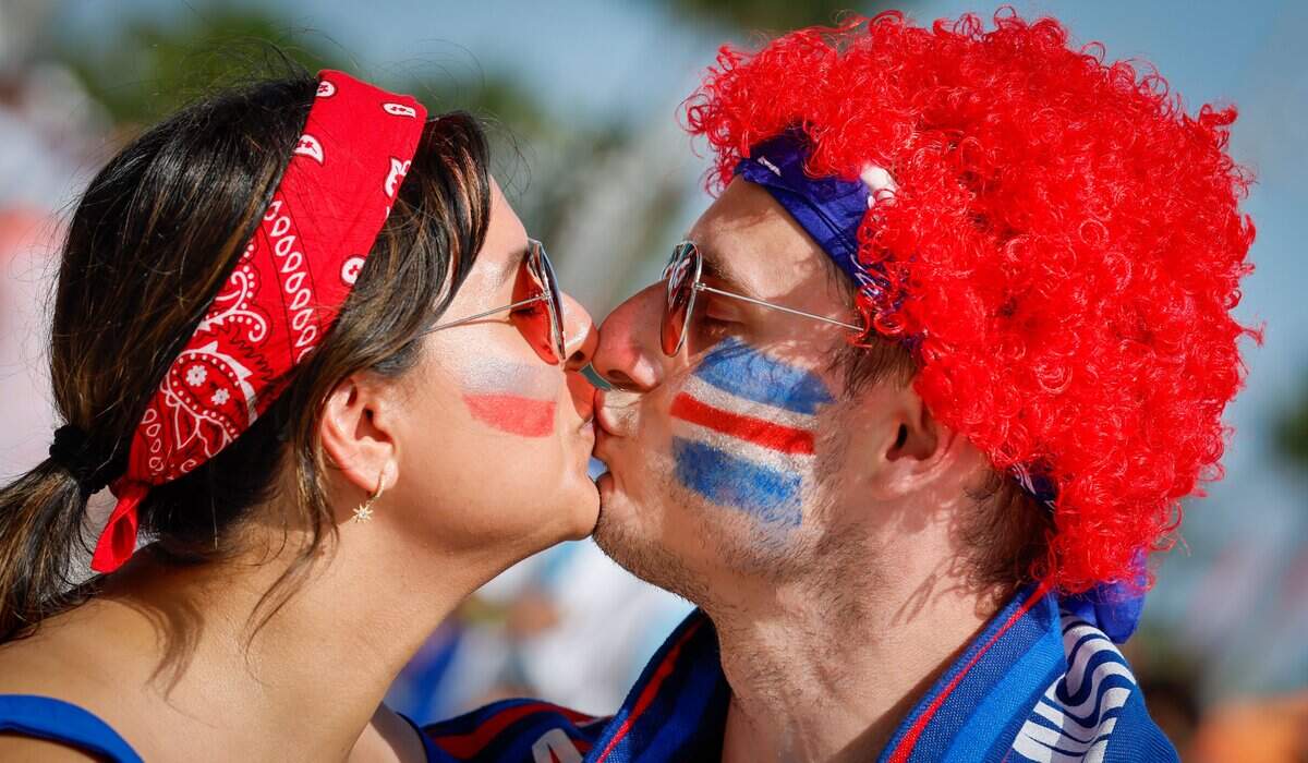 Cape Verde fans Beatriz Pardo and Marc De Boer kiss before the start of the FIFA World Cup 2026 Round of 32 soccer match between Argentina and Cape Verde at Hard Rock Stadium (Miami Stadium) on Friday, July 3, 2026, in Miami Gardens, Fla.