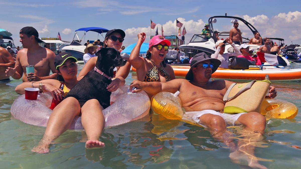 A busy, sunny day on the Haulover Sandbar before dredging began in 2022 and moved the floating party south to the Bal Harbour area. Partying on the water often means loud noise, and Miami-Dade County may crack down on the volume. But only at night. 
