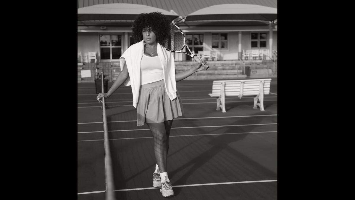Publicist Francesca Megan, photographed on Tuesday, Jan. 31, 2023, stays connected to her neighborhood and her Black roots through the game of tennis. She and her friends organize a de facto tennis club to play tennis at Moore Park’s Ashe-Buchholz Tennis Center. She feels playing tennis is a form of empowerment that has acknowledged the power of Black athletes in a primarily white sport. The Miami Herald reached out to 30-year-olds and under about being Black in Miami-Dade, the spaces they occupy, and how that reinforces their Black culture, identity, and pride.